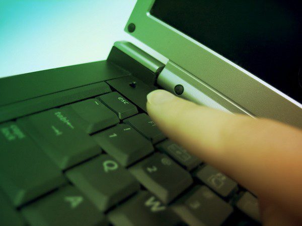 A picture of someone's finger tapping on a laptop keyboard